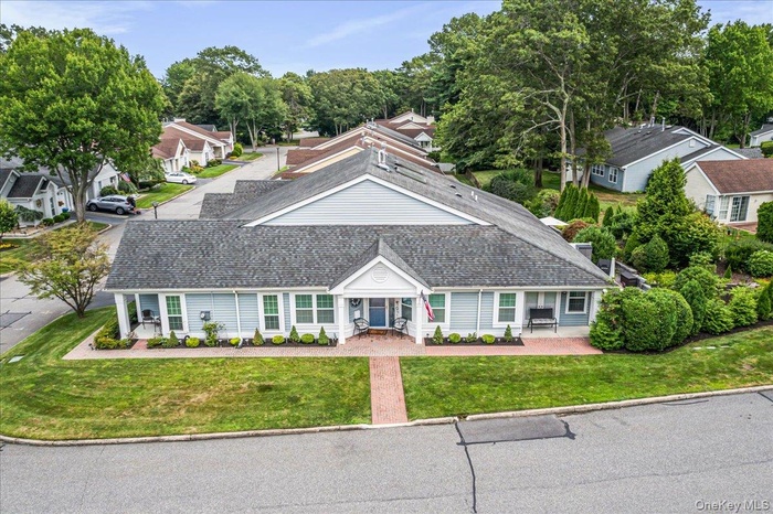 View of front of property with a shingled roof, a residential view, and a front yard