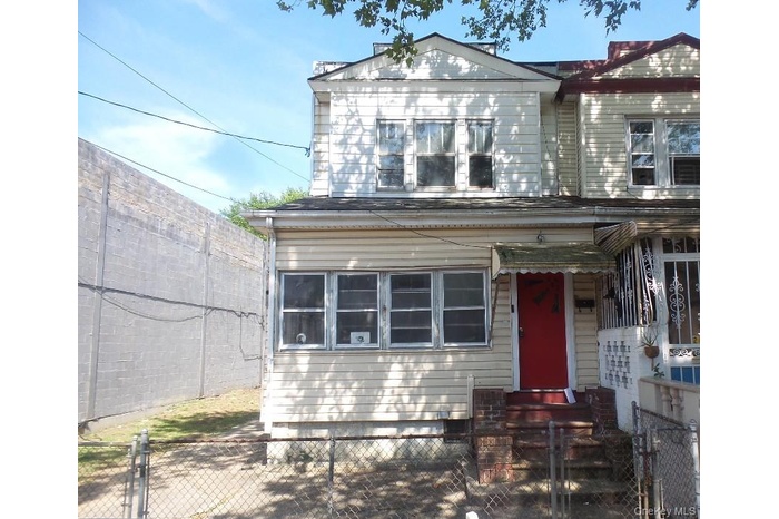 View of front of home featuring a fenced front yard and a gate