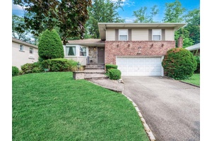 Welcome to this beautiful split level home nestled on a quiet, tree lined street in the Herricks School District.