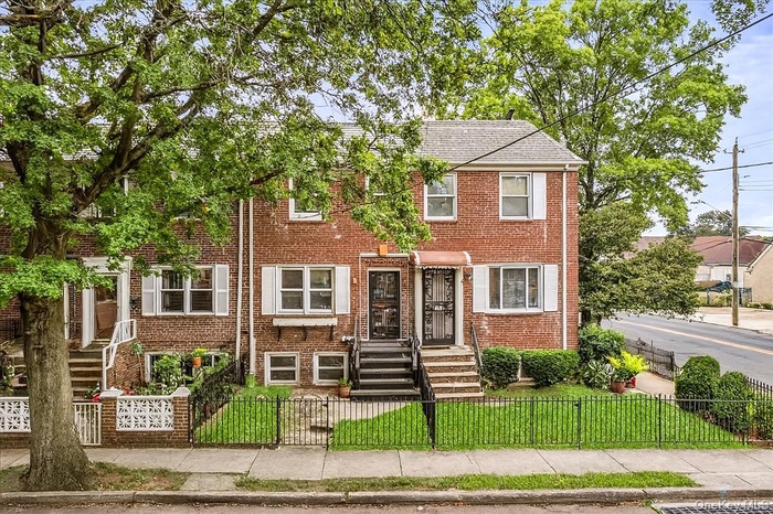 View of front of property with a fenced front yard and brick siding