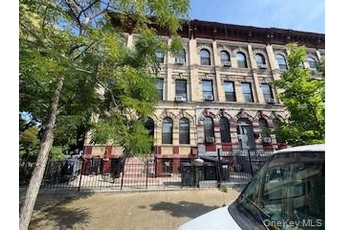 View of building exterior featuring a fenced front yard