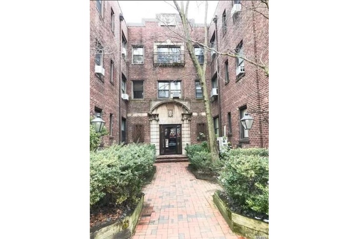 Doorway to property featuring brick siding