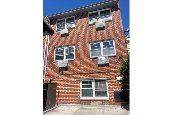 View of side of property featuring brick siding and cooling unit