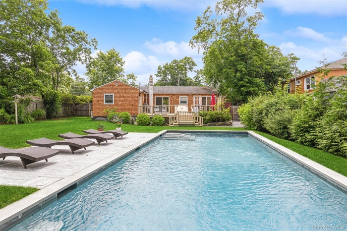 Outdoor pool with a deck and a patio area