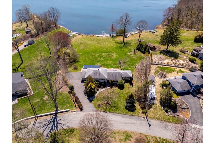 Birds eye view of property with a water view