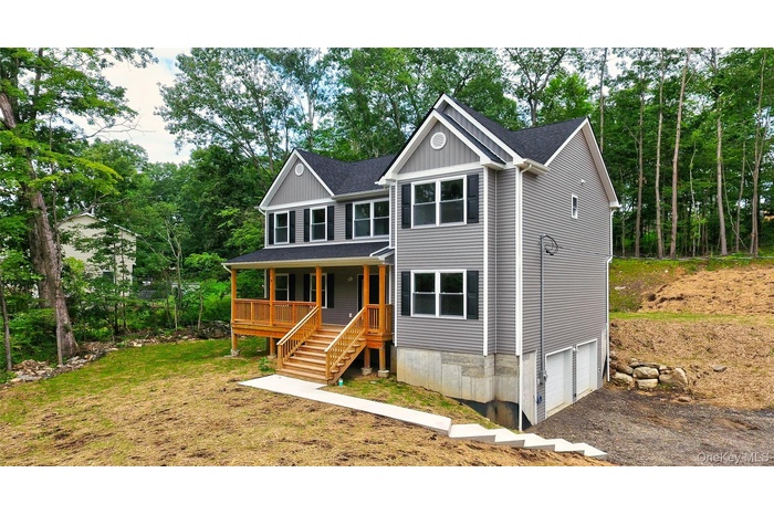 View of front of house featuring stairway, a garage, driveway, a shingled roof, and a front lawn