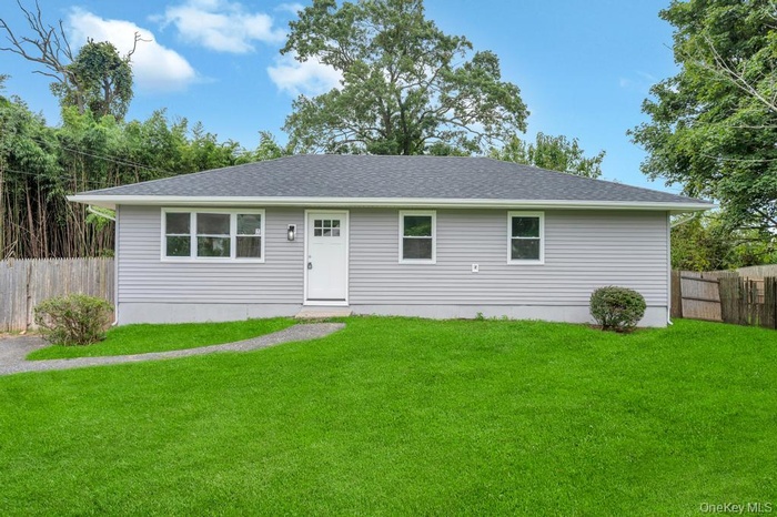Single story home featuring roof with shingles