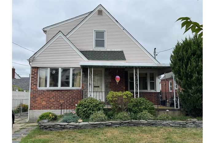 Bungalow featuring brick siding and a porch