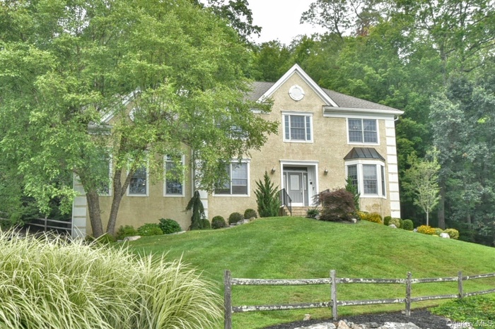 Colonial house featuring stucco siding