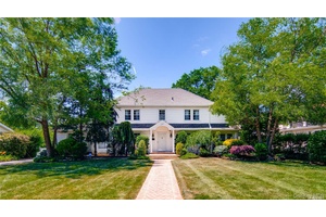 Welcome to this Classic Center Hall Colonial, nestled in the picturesque neighborhood of Cathedral Gardens.