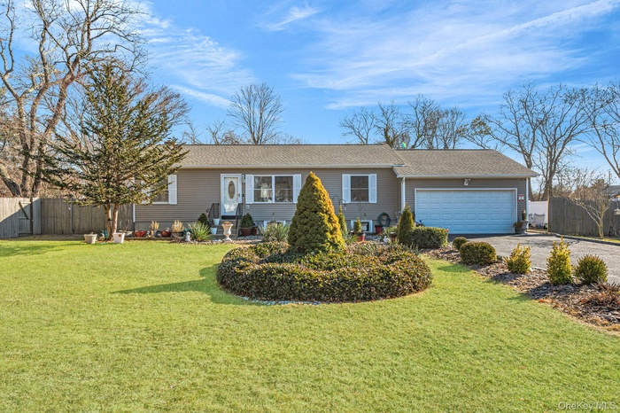 Single story home with gravel driveway, a garage, and roof with shingles