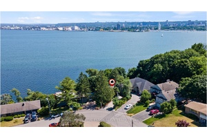 EXCEPTIONAL LAKEFRONT LIVING ON A NEARLY HALF ACRE HILLSIDE RETREAT !