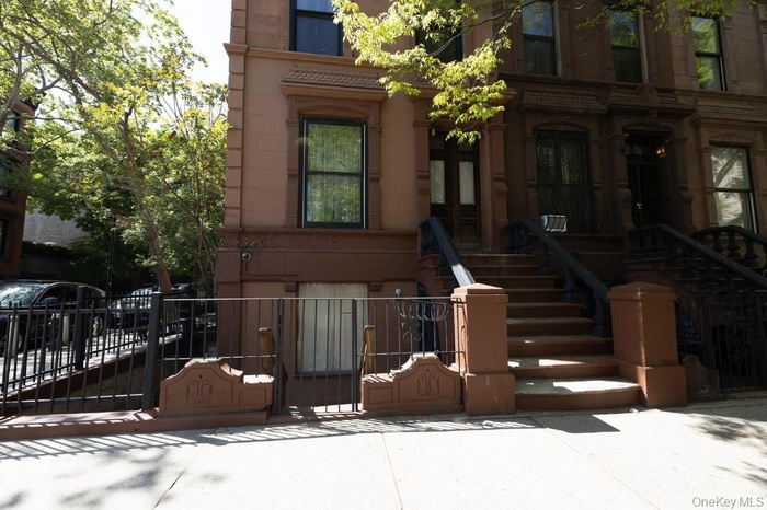 View of front of property featuring a fenced front yard and a gate