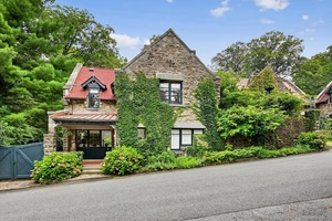 The Cotswell Cottage and stone stable build in 1876, is within The Historic Village and gated community of Tuxedo Park.