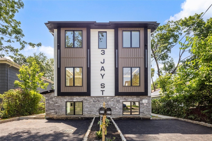 View of front of home with stone siding and uncovered parking