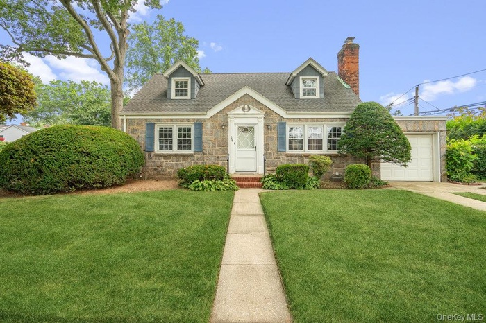 New Englander with stone a exterior al large front yard,, and 1.5 car attached EE garage