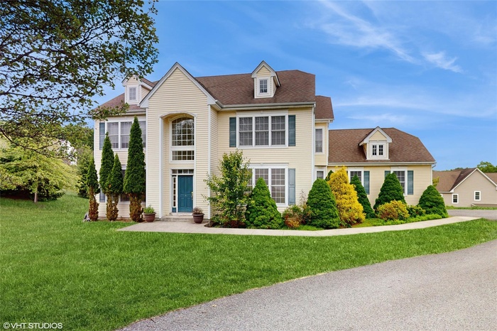 house with a front lawn and roof with shingles