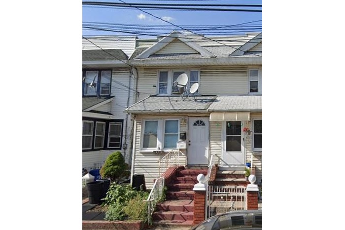 Townhome / multi-family property featuring entry steps and roof with shingles