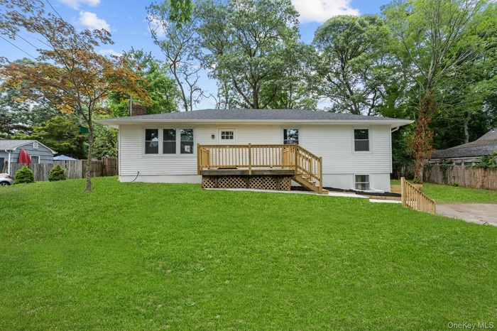 Back of house with a wooden deck and a chimney