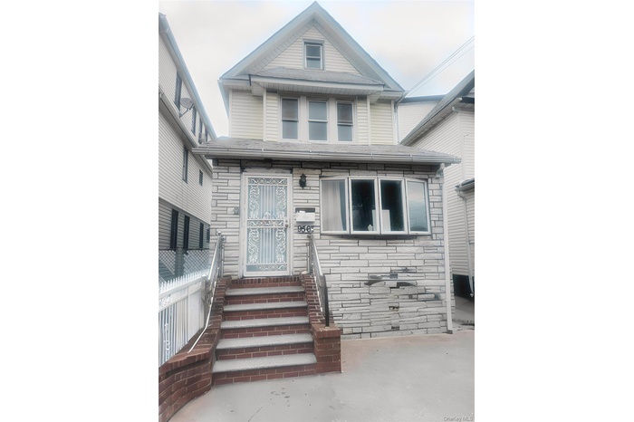 View of front of property with entry steps and stone siding