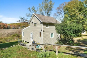 What a view ! This beautifully updated cottage style home is set on 1.