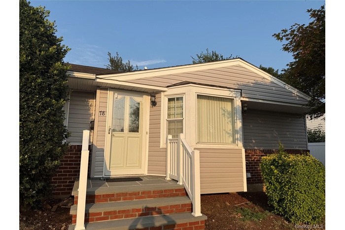 Doorway to property featuring brick siding
