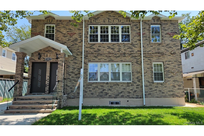 View of front of house featuring brick siding