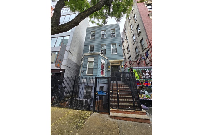 View of front facade with a gate and a fenced front yard