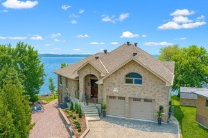 This exquisite Azilda home on the shores of Whitewater Lake was crafted through the owners incredible vision, offering timeless design and luxurious features on a coveted, south facing waterfront property.