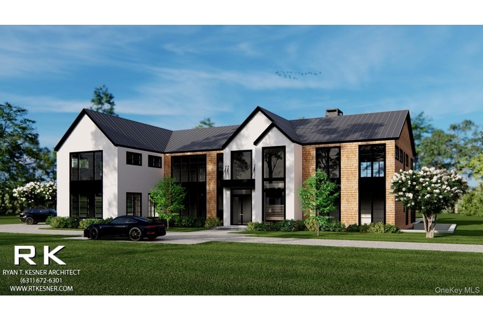 View of front facade featuring a front yard, a chimney, a metal roof, and brick siding