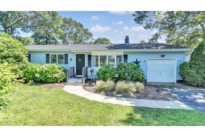 Perfectly situated on a quiet lane near the Shinnecock Canal, this impeccably updated Hamptons ranch exudes effortless sophistication and modern ease.