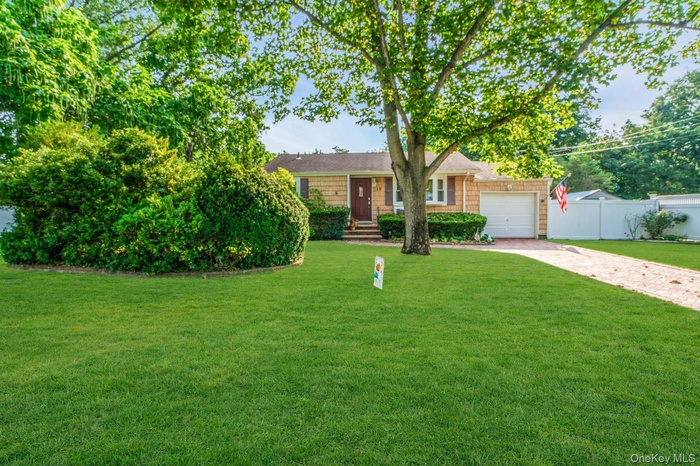 View of front of property with driveway and a garage