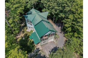 Extraordinary Three Bedroom Home with In Law Suite, Large Sunroom and a Huge Garage !