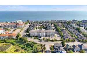 Wake up to the beauty of lakeside living in this rare top floor corner suite, where every glance out the window feels like a postcard.