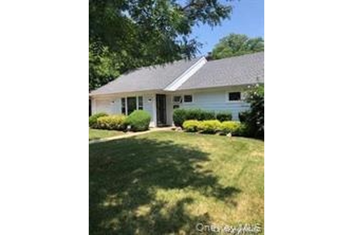 Single story home with a front lawn