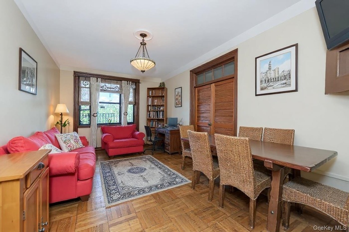 Living room /Dining space featuring crown molding and a desk