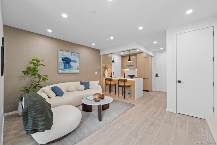 Living room with recessed lighting and wood finish floors