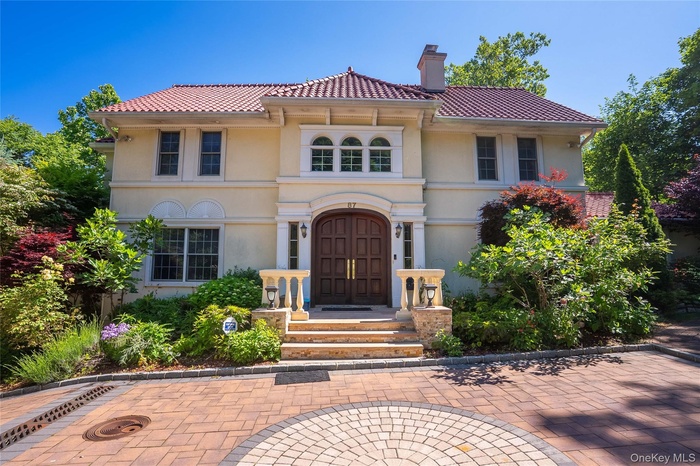 Mediterranean / spanish-style home featuring stucco siding and a chimney