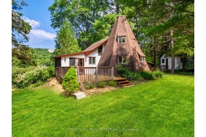 This beautiful Kennisis River front property features 267 feet of private shoreline and nearly 2 acres of land, making it an ideal retreat for nature lovers and outdoor enthusiasts.