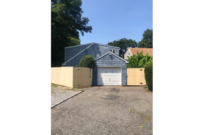 Garage with asphalt driveway