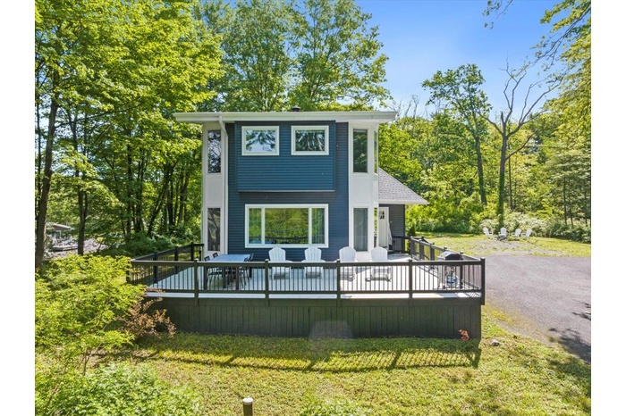 View of front of home featuring a front yard and a deck