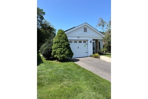 Beautiful Heather model. Spacious entry with wood floors, invites you into the home and gives an open view past the two season room to the private backyard.