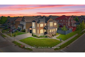Absolutely Stunning Sun Filled Corner Lot Home Featuring a Stone amp ; Brick Exterior with Double Door Entry !