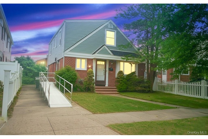 Bungalow featuring brick siding
