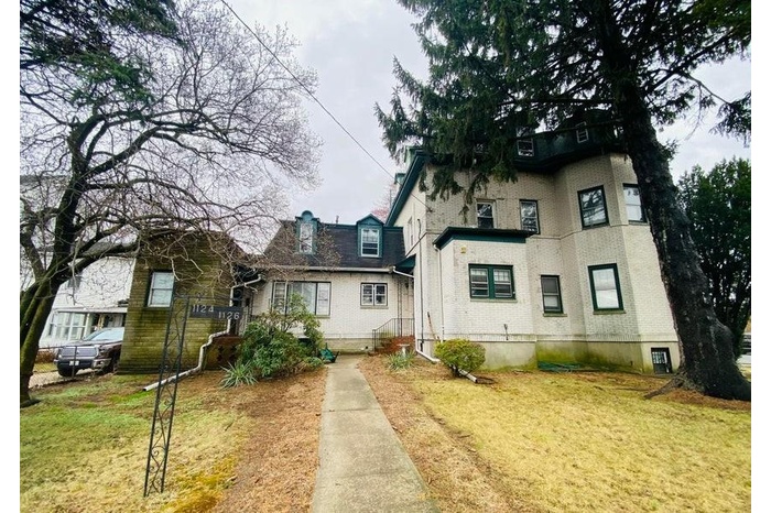 View of front facade featuring brick siding and a front lawn