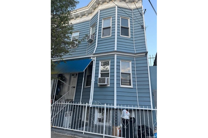 View of front of home featuring cooling unit