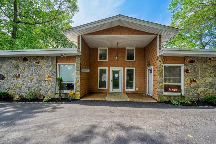 View of exterior entry featuring stone siding