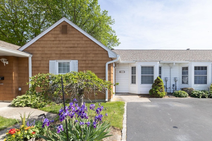 View of front of home featuring roof with shingles