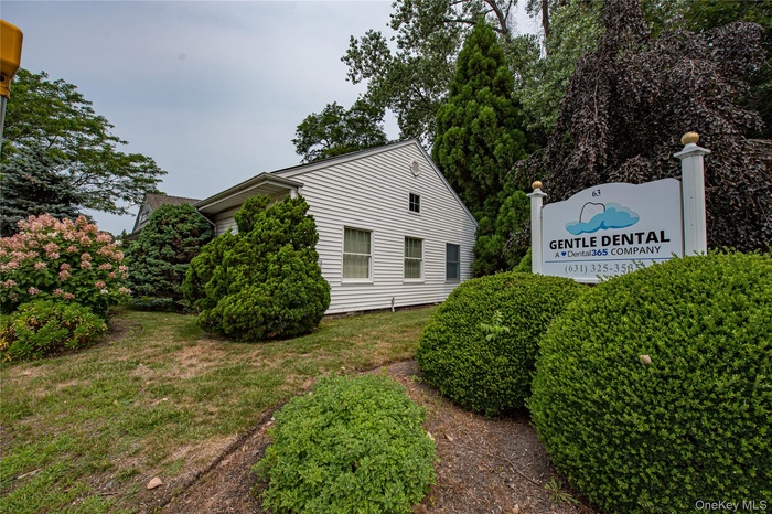 View of side of home with a yard