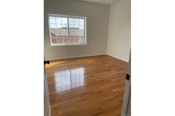 Empty room with wood finished floors and baseboards